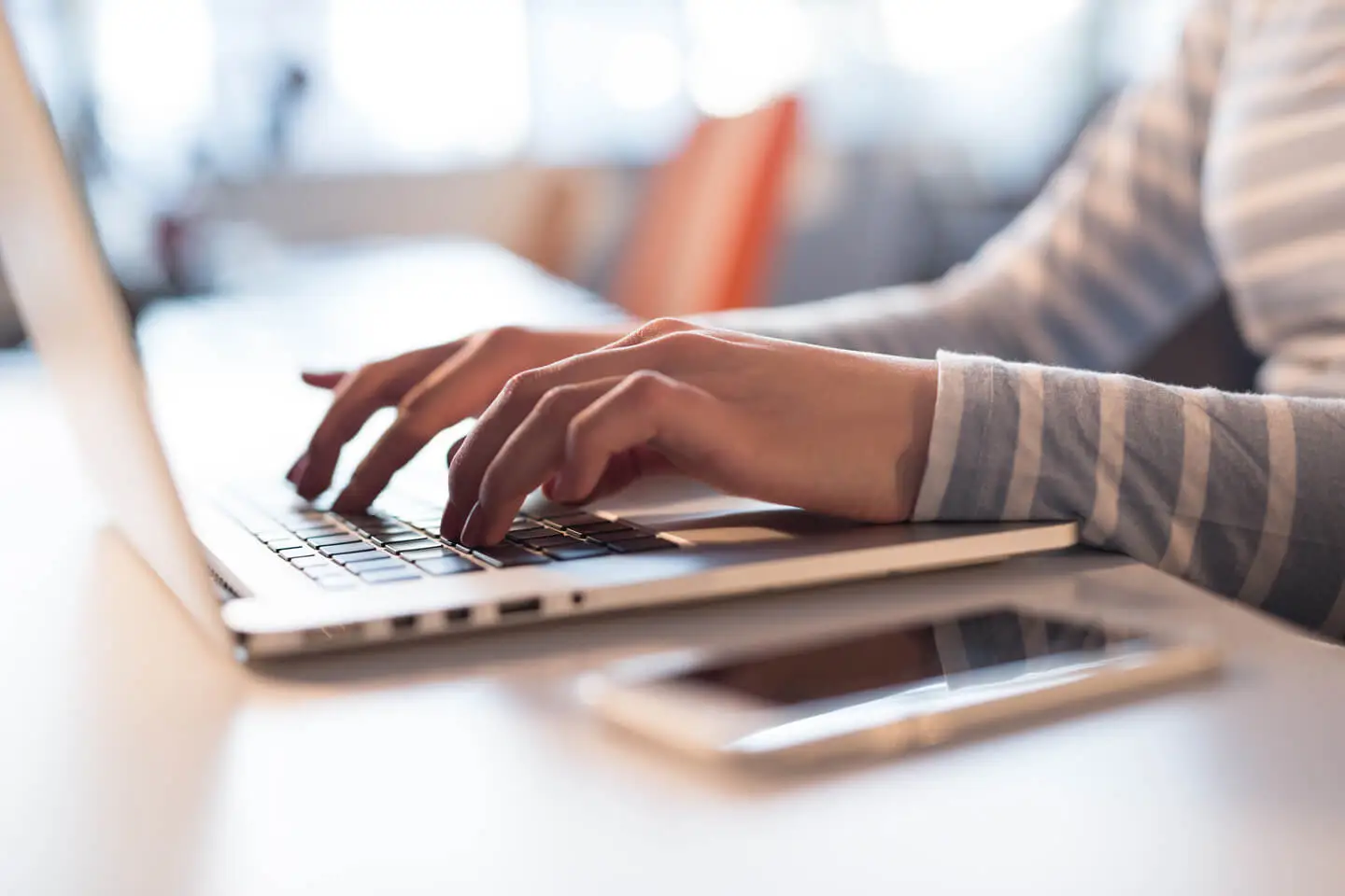 person typing on laptop