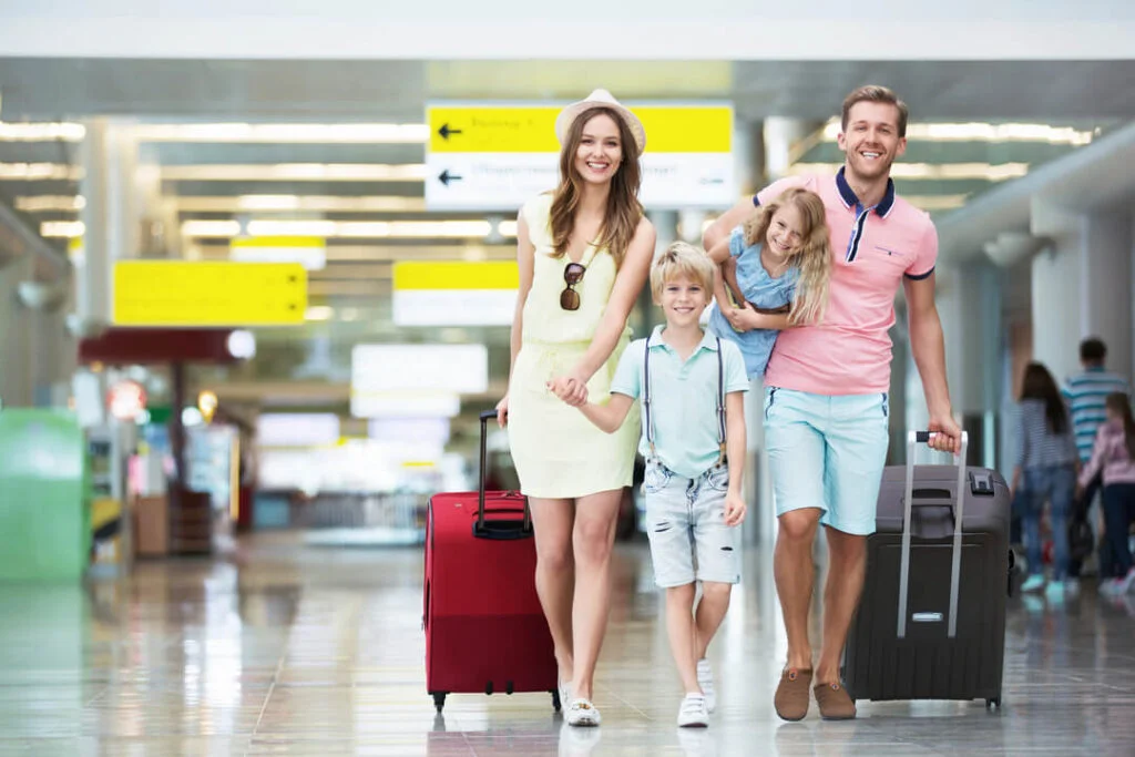 Family of four walking through the airport