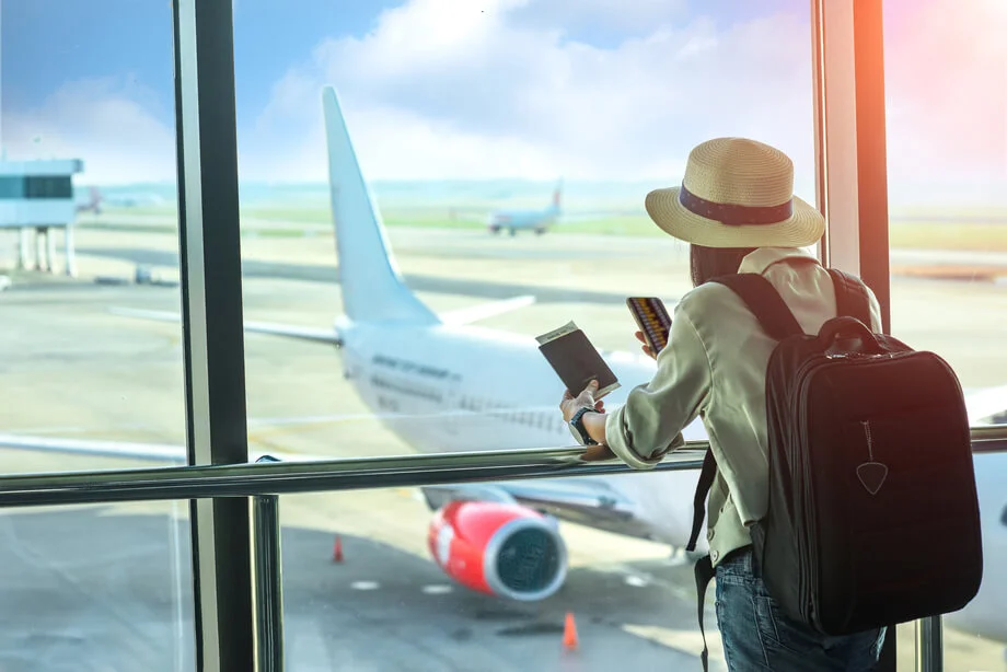 A girl scrolling her phone in the airport