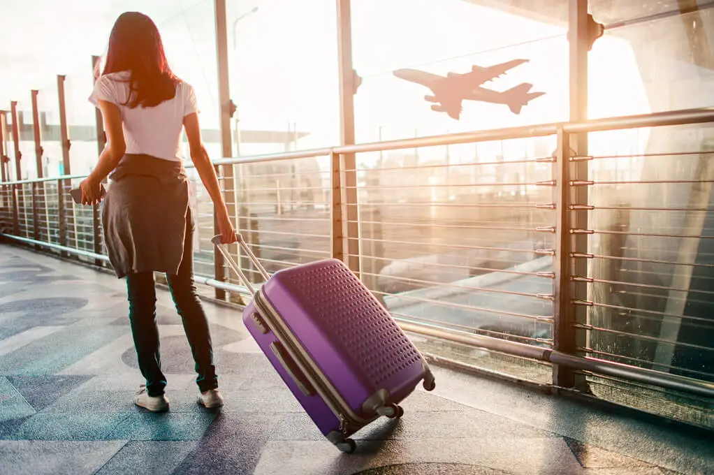 Woman in airport with luggage