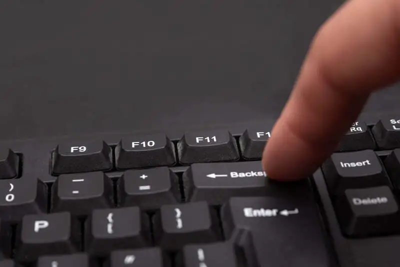 Finger pressing on the computer keyboard